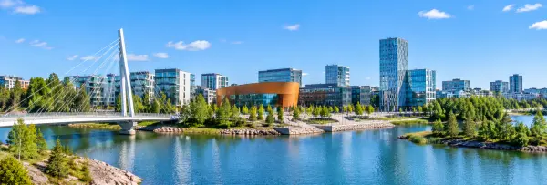 Panoramic view of Espoo, Finland, with modern waterfront architecture, blue waters, and lush Nordic greenery.