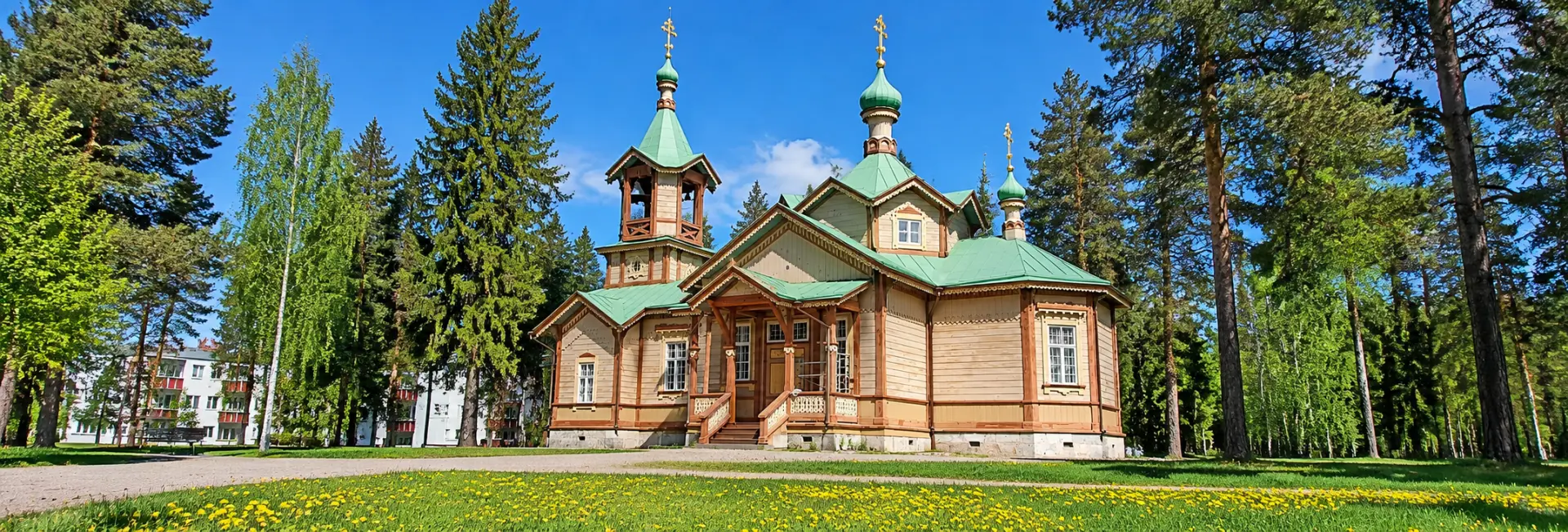Traditional wooden Orthodox church in Joensuu, Finland, surrounded by pine trees