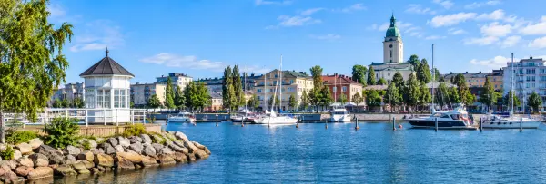 Kotka, Finland harbor with sailboats, waterfront buildings, and a historic green-domed tower