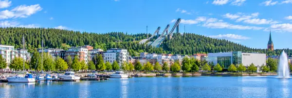 Lahti waterfront with ski jumps, Sibeliustalo, marina and forested hills in Finland