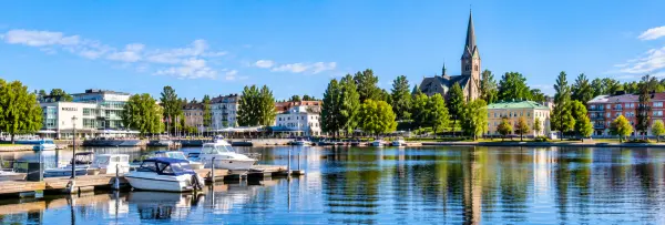 Mikkeli, Finland waterfront with boats, lakeside promenade, historic buildings, and cathedral tower