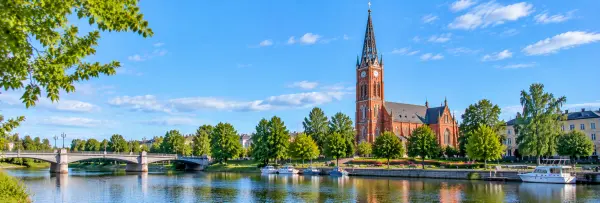 Pori city waterfront with Pori Church, a historic bridge, boats and green parks in Finland