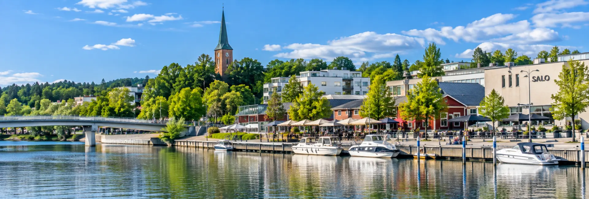 Salo, Finland waterfront with boats, a scenic promenade, and the town church tower