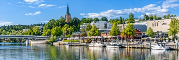 Salo, Finland waterfront with boats, a scenic promenade, and the town church tower