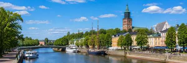 Turku, Finland, with the Aura River, historic buildings, boats, and Turku Cathedral