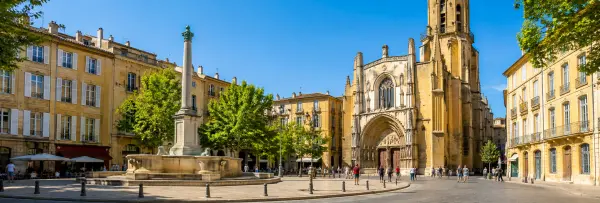 Aix-en-Provence historic square with a fountain, Provençal buildings and Saint-Sauveur Cathedral