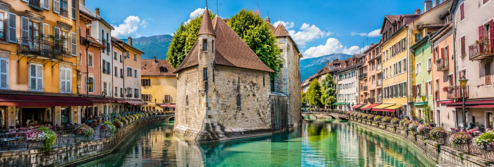 Annecy, France panoramic view of historic canals, colorful buildings and the French Alps
