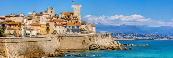 Antibes, France, with historic stone ramparts, colorful old-town buildings and the Mediterranean Sea