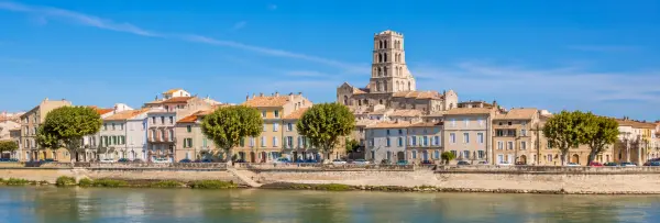 Arles, France, historic riverside town with colorful buildings and Romanesque church tower
