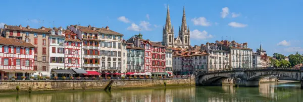 Bayonne, France, with colorful Basque houses, cathedral towers, and a historic bridge over the river