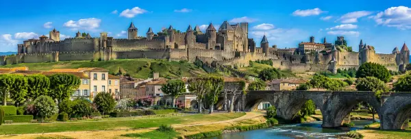 Carcassonne medieval citadel in France with fortified walls, towers, historic bridge and scenic riverside