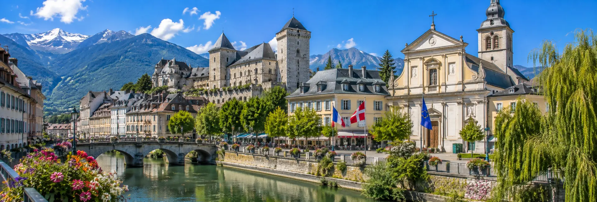 Chambéry, France, with a historic castle, riverside old town, and snow-capped Alpine mountains