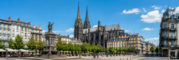 Clermont-Ferrand Cathedral with its distinctive black stone towers above a historic city square