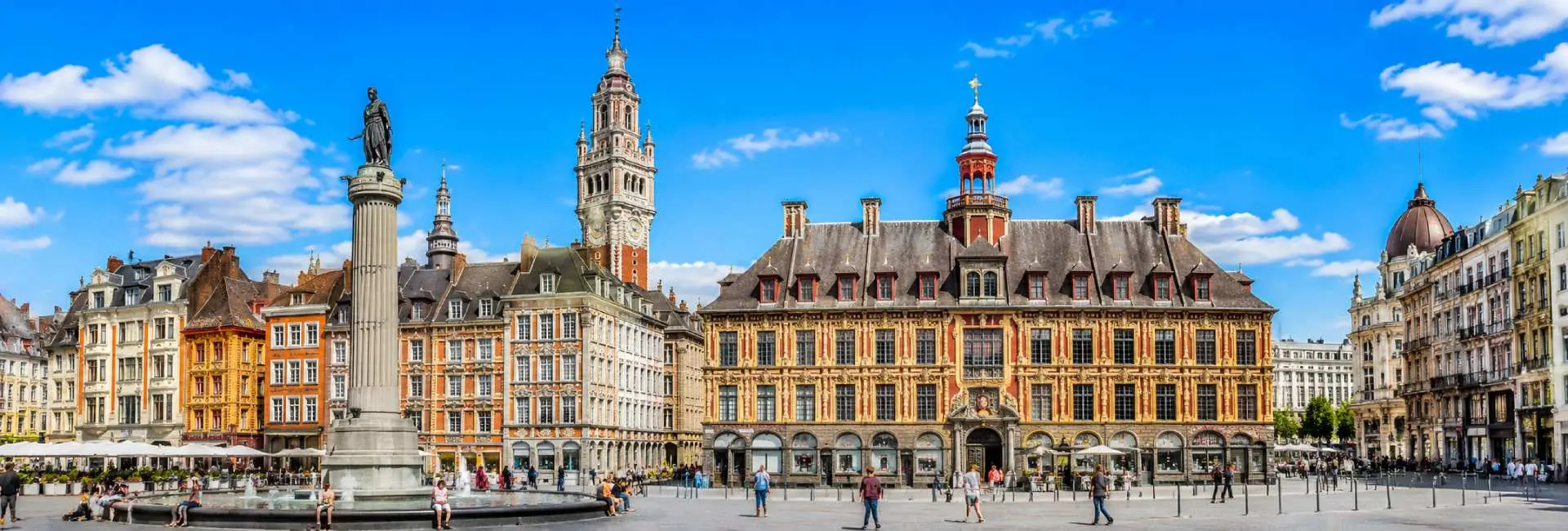 Lille, France historic Grand Place with ornate Flemish buildings and Lille belfry under a blue sky