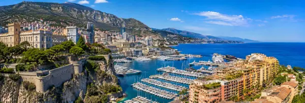 Monaco panoramic coastal view with Prince’s Palace, yachts, Mediterranean Sea and surrounding mountains