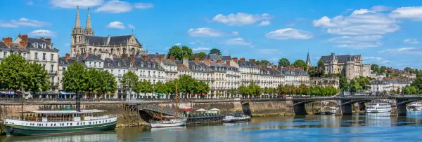 Nantes, France, with the Loire River, historic waterfront buildings, cathedral and riverside boats