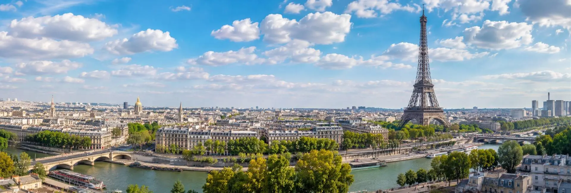 Panoramic daytime view of Paris featuring the Eiffel Tower