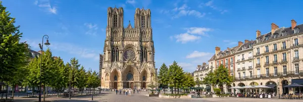 Reims Cathedral in France with its Gothic façade, twin towers and historic city square