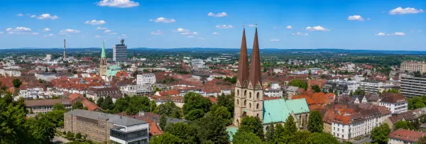 Bielefeld, Germany skyline with historic churches, Sparrenburg Castle tower, modern buildings, and green surroundings