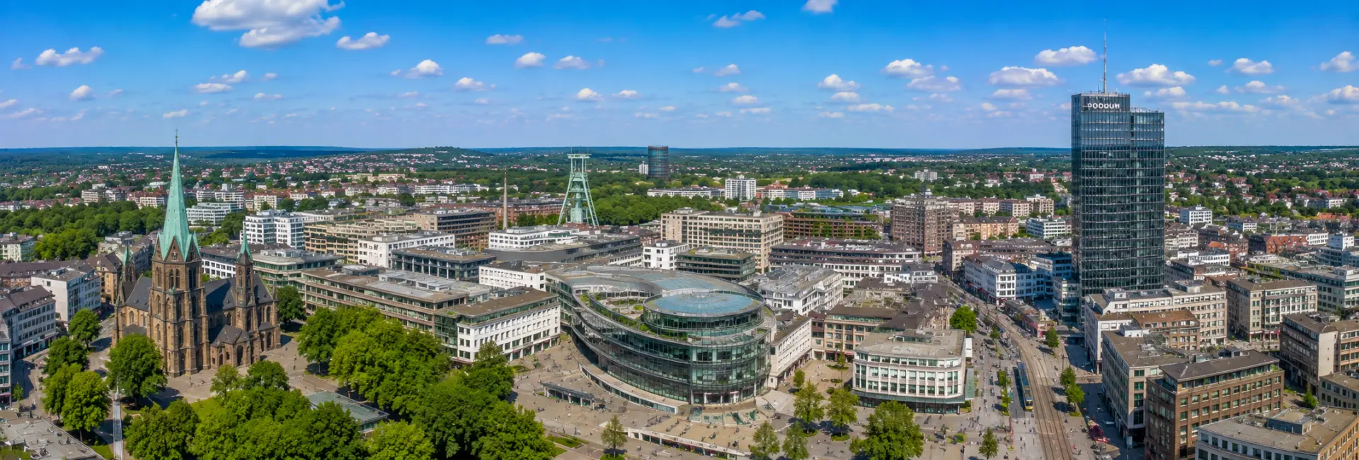 Bochum, Germany skyline with historic church, mining landmarks, modern buildings, and green surroundings