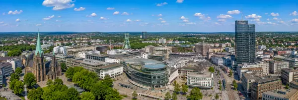 Bochum, Germany skyline with historic church, mining landmarks, modern buildings, and green surroundings