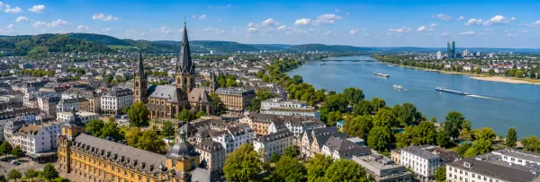 Bonn, Germany skyline with Bonn Minster, the Rhine River, and surrounding green hills