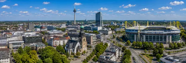 Dortmund, Germany skyline with historic church, city tower, modern buildings, and Signal Iduna Park