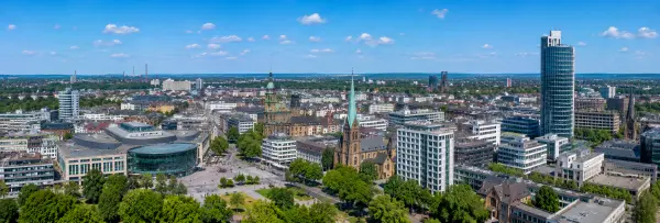 Essen, Germany skyline with historic churches, modern buildings, green parks, and the city center