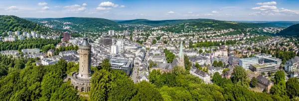 Aerial panoramic view of Hagen, Germany, surrounded by green hills and historic city architecture
