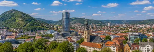 Jena, Germany skyline with JenTower, historic buildings and green hills