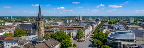 Mönchengladbach, Germany skyline with historic churches, city center, and surrounding greenery