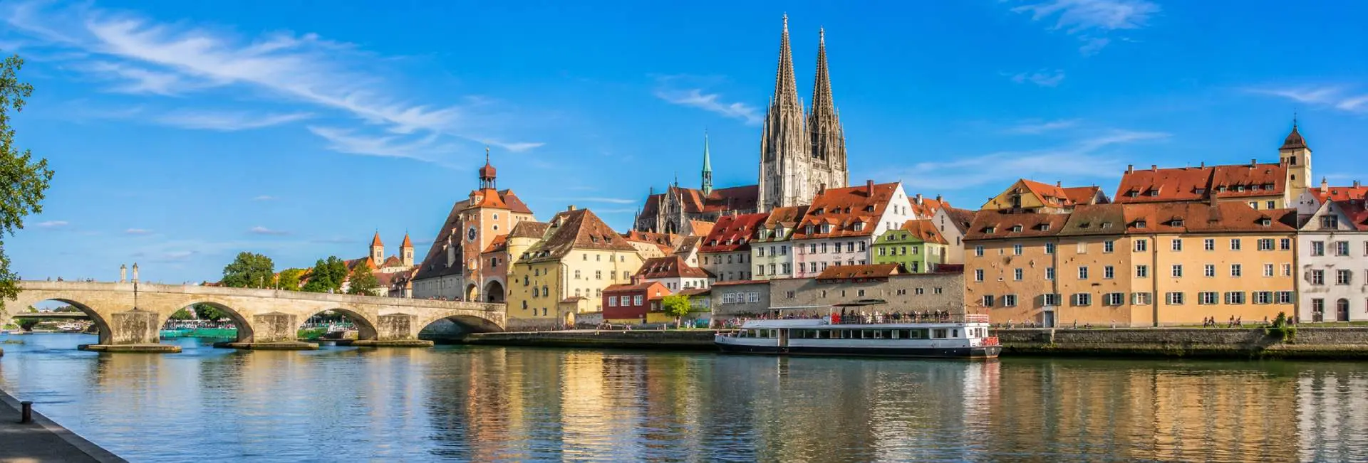 Regensburg, Germany historic old town with Stone Bridge, Danube River and Gothic cathedral