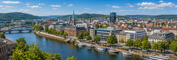 Saarbrücken, Germany skyline with Saar River, historic buildings and green hills