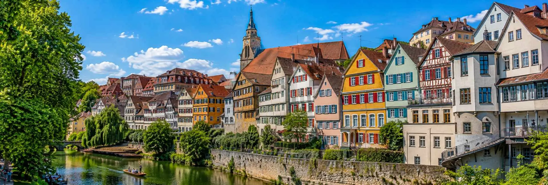Panoramic view of Tübingen, Germany, with colorful old-town houses, Neckar River and historic church tower
