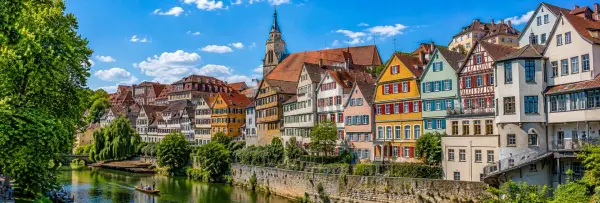 Panoramic view of Tübingen, Germany, with colorful old-town houses, Neckar River and historic church tower