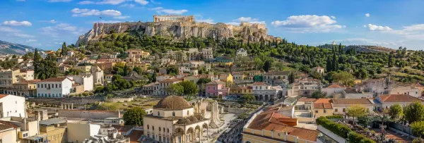 Athens cityscape with the Acropolis and Parthenon under a bright blue sky