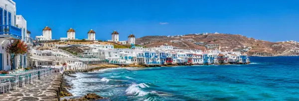 Mykonos, Greece, with whitewashed buildings, iconic windmills and turquoise Aegean Sea