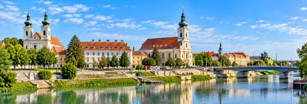 Győr, Hungary, with baroque architecture, historic buildings, a riverside promenade, and bridge.