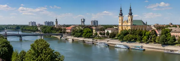 Szolnok, Hungary skyline along the Tisza River with a historic church and riverside bridge