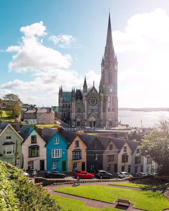 St. Fin Barre’s Cathedral overlooking colorful houses and the harbor area in Cork, Ireland