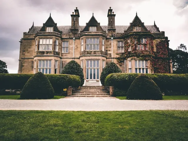 Historic country house in Killarney surrounded by manicured hedges and green lawns