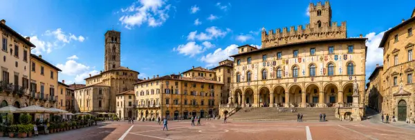 Arezzo, Italy historic Piazza Grande with medieval buildings, arcades, and the grand Palazzo delle Logge