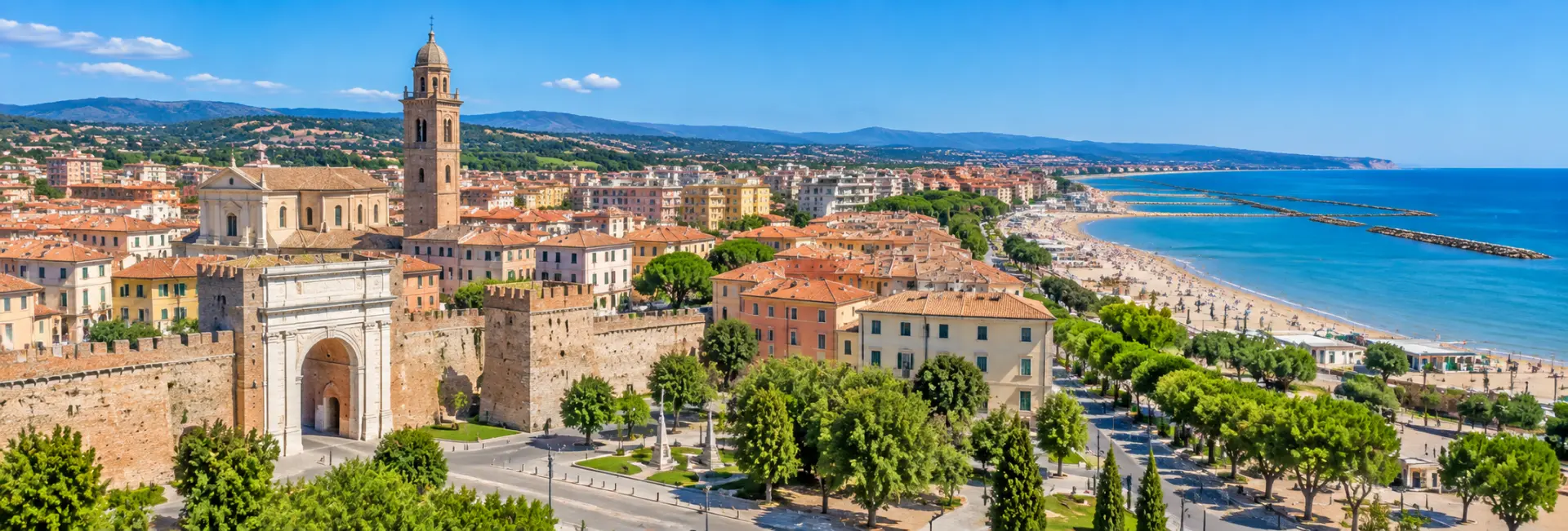 Panoramic view of Fano, Italy, with historic walls, terracotta rooftops, Adriatic beaches and surrounding hills.