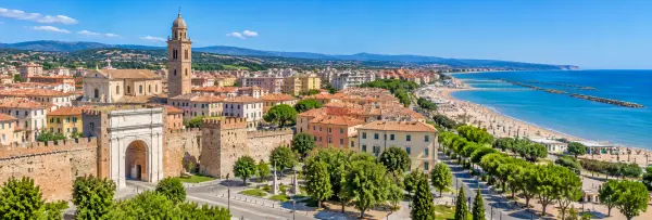 Panoramic view of Fano, Italy, with historic walls, terracotta rooftops, Adriatic beaches and surrounding hills.