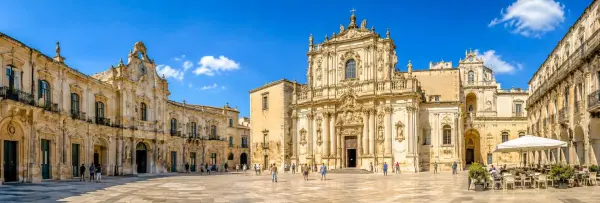 Lecce, Italy historic Baroque square with ornate architecture under a bright blue sky