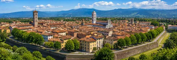 Lucca, Italy with historic city walls, terracotta rooftops, medieval towers and Tuscan mountains