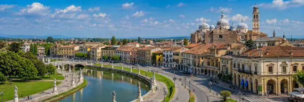 Panoramic view of Padua, Italy, with historic buildings, canals, bridges, and the Basilica of Saint Anthony