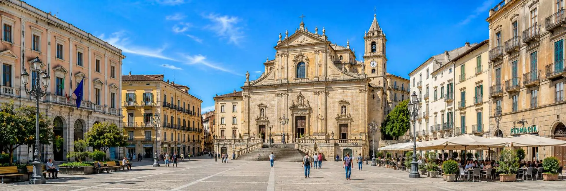 Sassari, Italy historic city square with ornate architecture, cathedral, and lively outdoor cafés