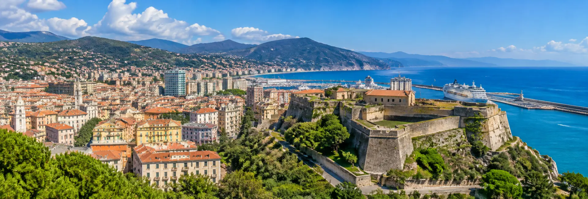 Panoramic view of Savona, Italy, with Priamar Fortress, historic city rooftops, harbor and Ligurian coast.