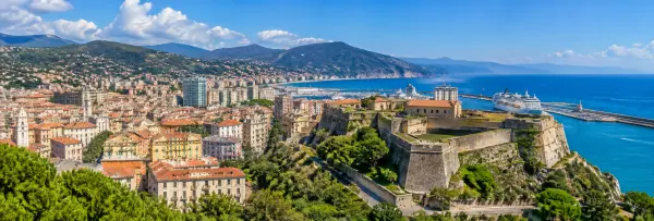Panoramic view of Savona, Italy, with Priamar Fortress, historic city rooftops, harbor and Ligurian coast.